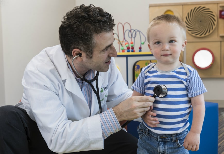 Doctor listening to childs heart