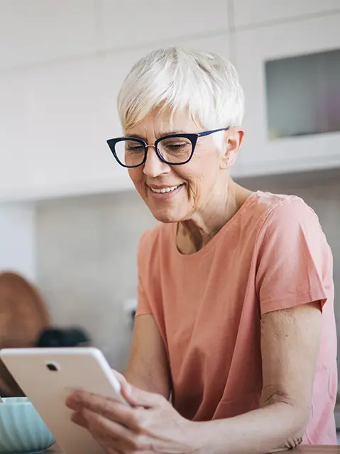 A woman using a tablet for telehealth