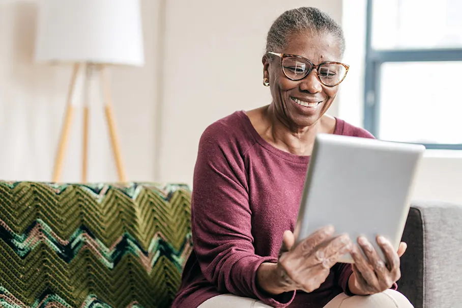 Elderly woman using a tablet for telemedicine