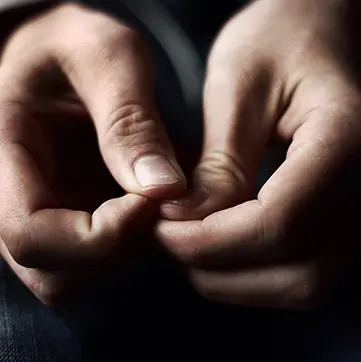 Man picking at his nails