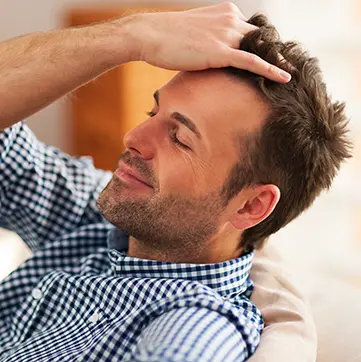 Man running hand through hair