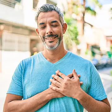 Man with hands on his chest