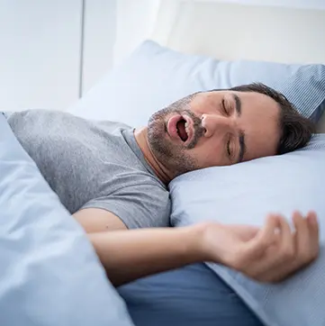 Man snoring in bed