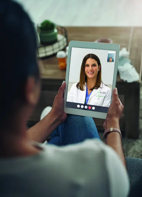 A woman using a tablet for telehealth