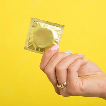 Woman holding a condom