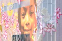 Mural of a child's face surrounded by flowers