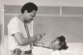 Robert Jordan, MD, giving a girl a check-up