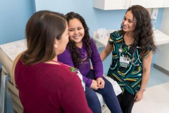 Rush care providers with a young patient