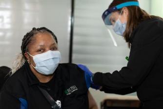 A Rush employee receiving a COVID-19 vaccine