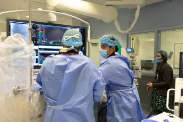 Electrophysiologist monitoring the electrical system and rhythms of the heart during operation.