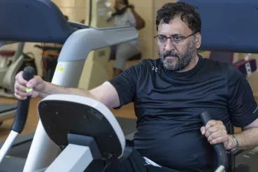 A cardiac rehab patient exercises on an elliptical training machine at Rush.