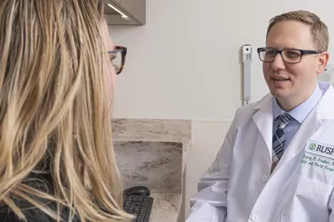 Henry Govekar, MD, talks to a patient