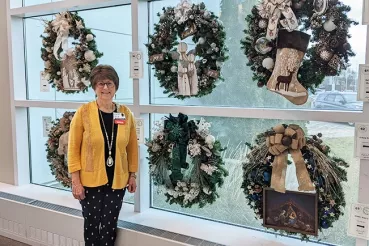 Louise Fazio with wreaths at Rush Copley