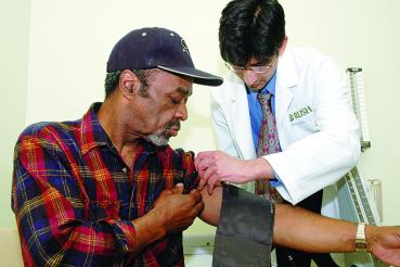 Man getting blood pressure taken by doctor