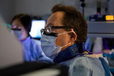 irving waxman wearing a mask and spectacles during a procedure in an operating room