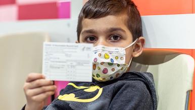 Boy with vaccination certificate