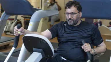 A cardiac rehab patient exercises on an elliptical training machine at Rush.