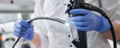 An endoscopist holding an endoscope