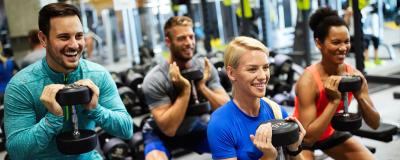 Group of people in fitness class holding weights 