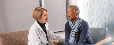 RUSH breast cancer specialists speaking with patient.