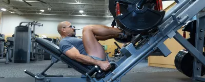 Man on leg press machine